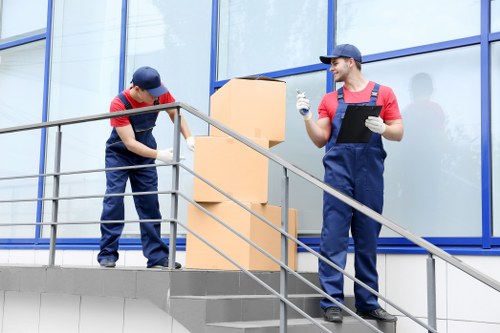 Professional movers handling boxes and furniture during a Holborn relocation