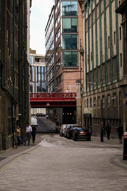 The image shows a row of multi-storey Victorian-style buildings on a busy street in Holborn, with ground-floor retail shops including a pet store and various other businesses. The buildings have ornat